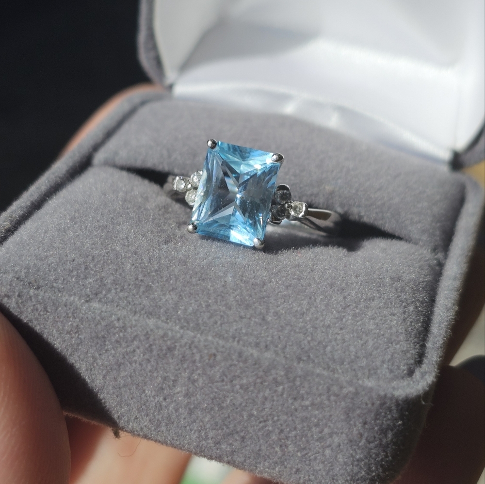 10k white gold blue topaz and diamond ring 7.25. This is in between about 3.5 -